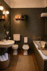 a bathroom with a sink and a toilet and a bath tub at Terracqua Retreat I Essence of Tuscany in Chiusi +29 photos