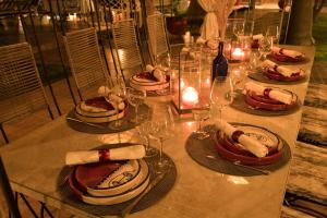 a table with plates of food and wine glasses at Kasbah Beldy Chic Marrakech, heated pool, spa in Marrakesh +58 photos