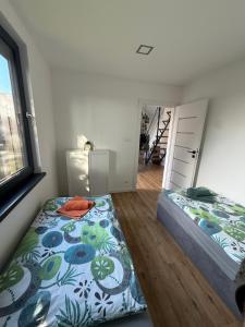 a bedroom with two beds and a window at BananaHouse in Kruszwin +58 photos