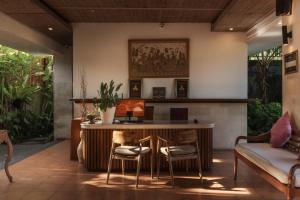 a living room with a table and chairs at Dedary Resort & Spa Ubud by Ini Vie Hospitality in Ubud