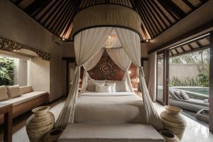 a bedroom with a bed with a canopy at Dedary Resort & Spa Ubud by Ini Vie Hospitality in Ubud +28 photos