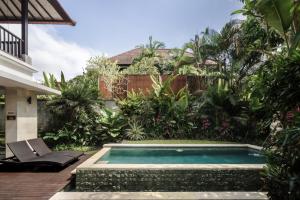 a swimming pool in the backyard of a house at Dedary Resort & Spa Ubud by Ini Vie Hospitality in Ubud