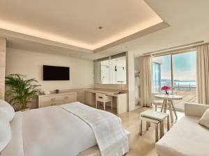 a bedroom with a bed and a desk and a television at Hotel Greges in Munakata +18 photos