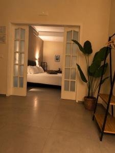 a bedroom with a bed and a potted plant at VK Rooms in Bari +43 photos