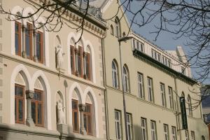 a building with statues on the side of it at Villa Nord in Trondheim