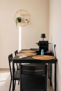 a black table with chairs and a printer at VK Rooms in Bari