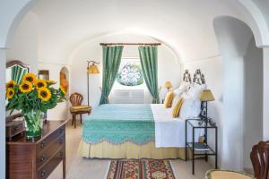 a bedroom with a large bed with a window at Masseria San Domenico - Preferred Hotels & Resorts in Savelletri di Fasano +74 photos