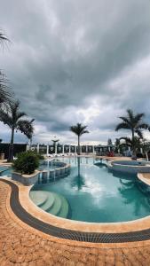 a swimming pool with palm trees in a resort at GL Luxe Suites in Tatu City