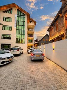 a group of cars parked in front of a building at Hotel Belvior Estate in Srinagar