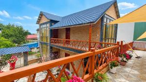 a house with a balcony with a blue roof at Tình's Homestay in Ninh Binh +59 photos