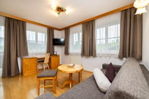 a living room with a couch and a table at Appartment Ransburggut in Flachau