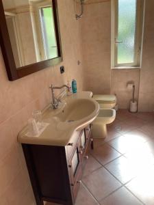 a bathroom with a sink and a toilet at Pink House in Perdifumo +32 photos