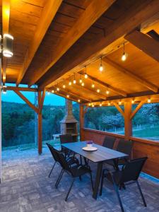 a patio with a table and chairs and lights at Przystanek Prządki in Czarnorzeki