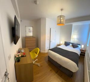 a bedroom with a bed and a desk and a table at Maya's Lodge in Dublin