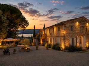 an old stone building with a sunset in the background at Terracqua Retreat I Essence of Tuscany in Chiusi