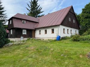 a large white house with a red roof at chata Pupalka in Kořenov