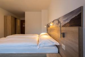 Un ou plusieurs lits dans un hébergement de l'établissement Matterhorn Inn