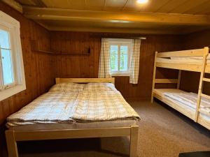 a bedroom with two bunk beds in a cabin at chata Pupalka in Kořenov
