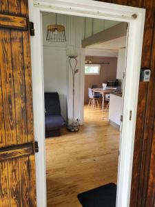 a door leading into a living room with a table at Chalets du Causse 4 in Gelle