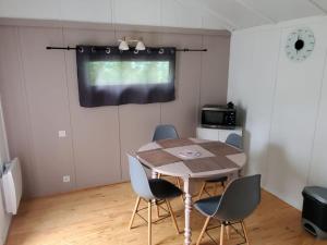 a dining room with a table and chairs at Chalets du Causse 4 in Gelle