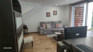 a living room with a couch and a table at La Quinta Adosado in Santa Úrsula