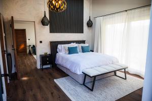 a bedroom with a white bed with blue pillows at Retreat 10 in Beccles
