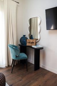 a room with a table with a mirror and a chair at Retreat 10 in Beccles