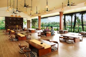 a large room with tables and chairs and windows at Flamingo Tan Trao Resort Managed by Flamingo Hotels & Resorts in Sơn Dương