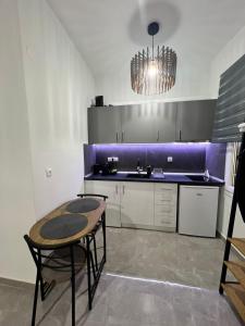 a kitchen with a table and a purple wall at Drama Homes Argiroudi in Drama