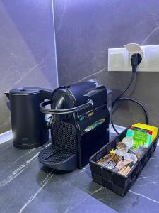 a table with a coffee maker and a basket of food at Drama Homes Argiroudi in Drama
