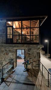 a house with a stone wall and a balcony at Casa rural Mirador, Balneario Histórico de Cortegada in Cortegada