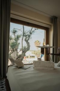 a room with a window with a bed with a book at Afrodite Luxury Residence & Spa in Pescara +218 photos