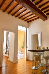 a living room with a table and chairs in it at Dimora storica - Palazzo Barabesi in Siena