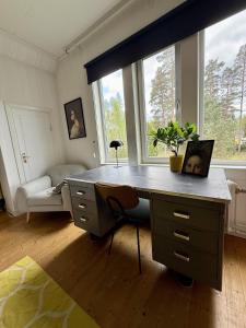 a desk in a room with a large window at SwedenWoods in Hagfors +19 photos
