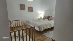 a bedroom with a bed with a white bedspread and a staircase at La Quinta Adosado in Santa Úrsula +29 photos