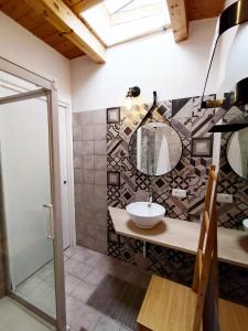a bathroom with a sink and a mirror at Santanna106 in Santa Domenica +15 photos