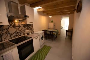 a kitchen with white appliances and a dining room at Santanna106 in Santa Domenica