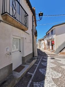 a street with a white door on a building at Santanna106 in Santa Domenica