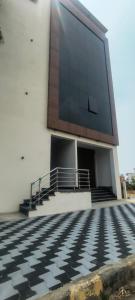 a building with stairs and a large window at Sky Light Mysore in Mysore South +3 photos