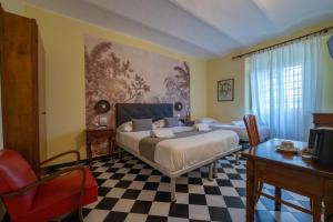 a bedroom with a bed and a checkered floor at Villa Fieschi Boutique Hotel in Lavagna