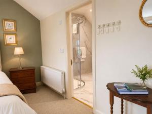a bedroom with a shower and a glass door at Corrib View Country House in Killarone +1 photo