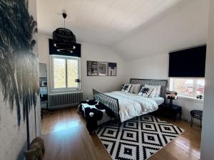 a bedroom with a bed and a rug at SwedenWoods in Hagfors