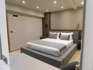 a bedroom with a large bed in a room at SFERA Boutique Rooms in Iaşi