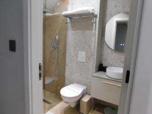 a bathroom with a shower and a toilet and a sink at SFERA Boutique Rooms in Iaşi +34 photos