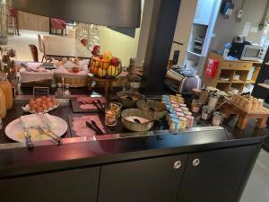 a kitchen counter with a bunch of food on it at Kyriad Blois Nord in Blois