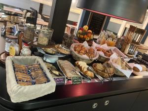 a buffet with many different types of food on a counter at Kyriad Blois Nord in Blois