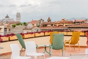 a row of chairs and tables on a roof at RELAIS DELL'USSERO Pisa centro in Pisa