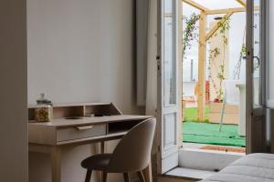 a kitchen with a desk and a chair next to a door at RELAIS DELL'USSERO Pisa centro in Pisa