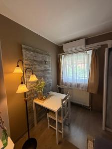 a dining room with a white table and a window at Kovács Vendégház in Bük