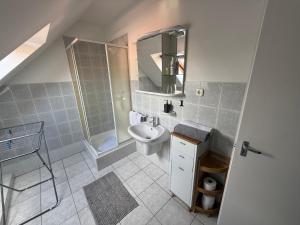 a bathroom with a sink and a toilet and a mirror at Kovács Vendégház in Bük +25 photos
